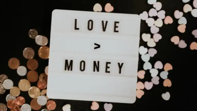 A sign with love is greater than money written on it, with money and hearts behind the sign, relating to financial stewardship.