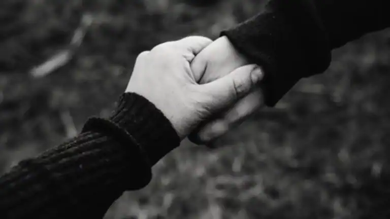One person holding another person's hand