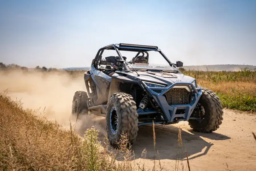 Off-road PDF vehicle in action on dirt trail, showcasing durability and performance for outdoor adventure enthusiasts.