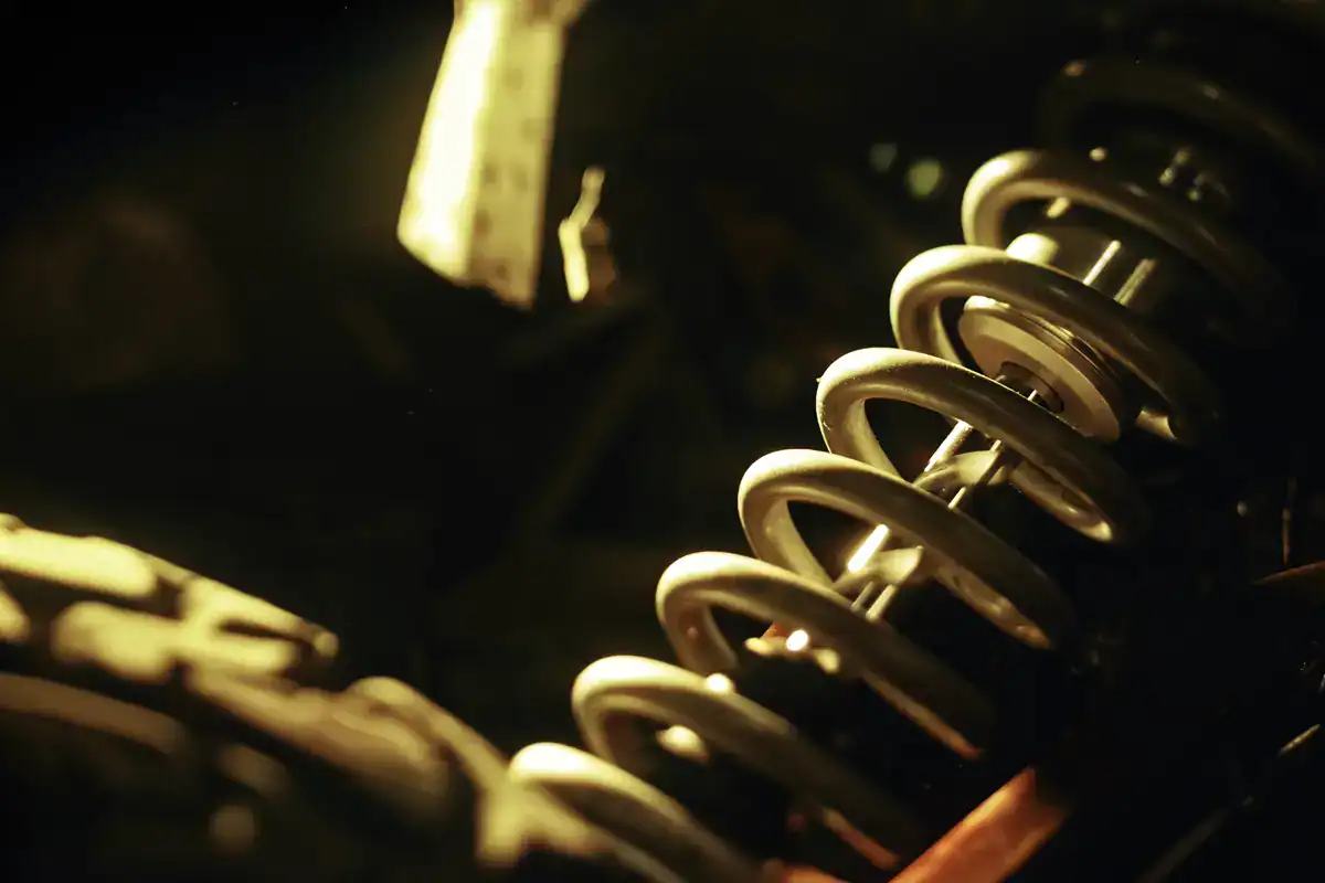 Suspension coil component for automotive applications, showcasing high-quality metal springs used in vehicle shock absorbers for enhanced ride stability and comfort.