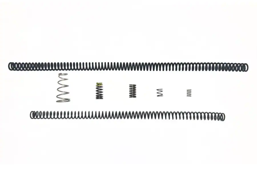 Spring coil set components for manufacturing and repair, showcasing various sizes and strengths used in industrial applications.