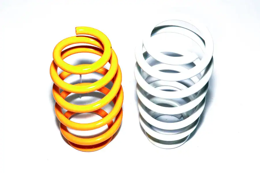 Colorful compression springs used in industrial applications at CHUHATSU North America, Inc. for manufacturing and automotive industries.