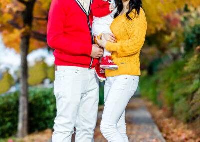 A family posing for a photo in the fall.