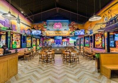 The interior of a restaurant with colorful murals.