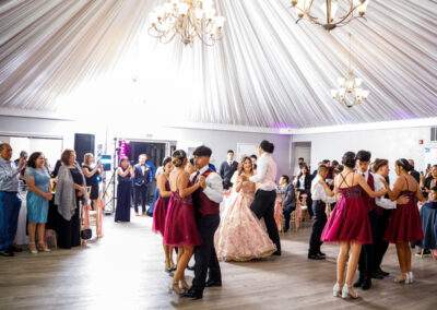 A group of people dancing at a wedding reception.