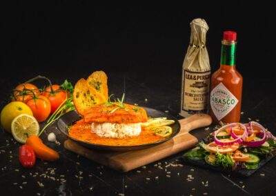 A plate of food with a bottle of sauce on it.