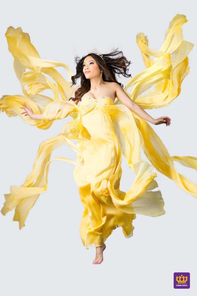 CineCrown fashion photography A woman in a yellow dress flying in the air.