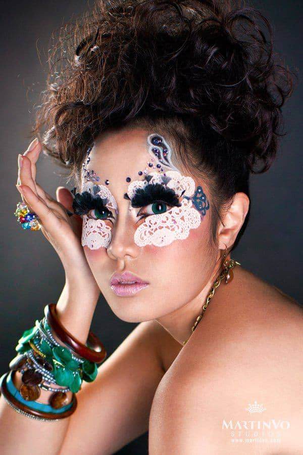 CineCrown fashion photography A woman with makeup on her face is posing for a photo.