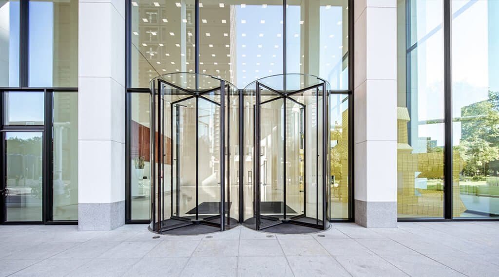 Modern glass revolving door at a commercial building.