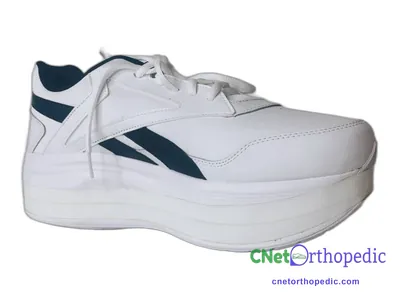 Shoe lift added to a women's white Reebok sneaker