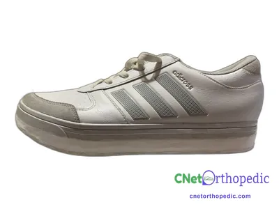 Shoe lift added to a women's grey Adidas sneaker