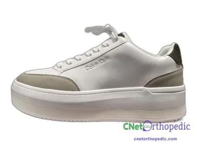 Shoe lift added to a women's white Calvin Klein sneaker