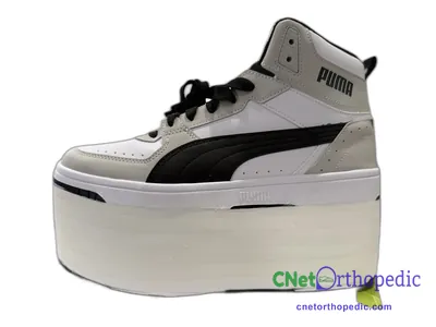 Shoe lift added to a women's grey Puma sneaker