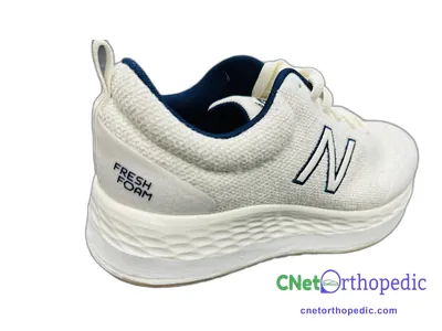 Shoe lift added to a women's white New Balance sneaker