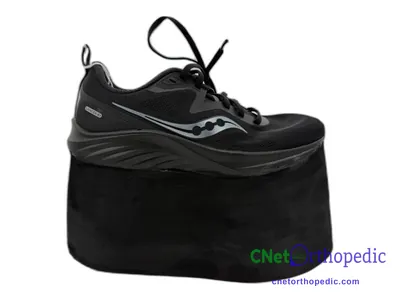 Shoe lift added to a women's black Saucony sneaker