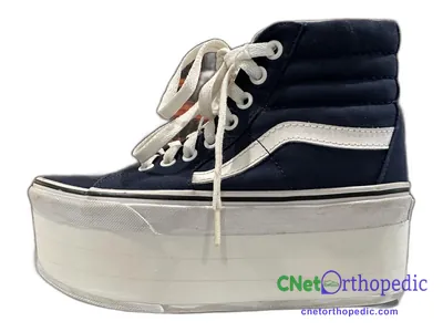 Shoe lift added to a women's black Vans SK8-Hi sneaker