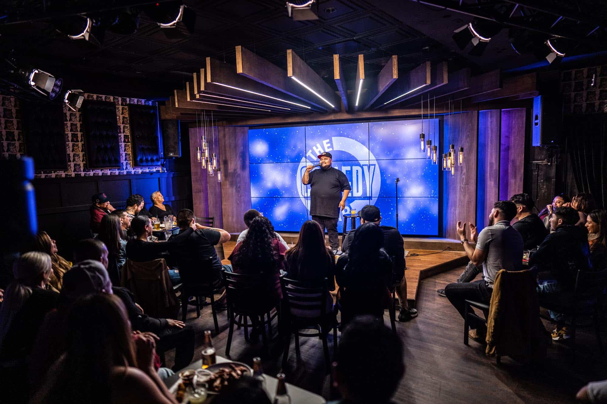 Comedian performing live at The Comedy Bar in front of the audience