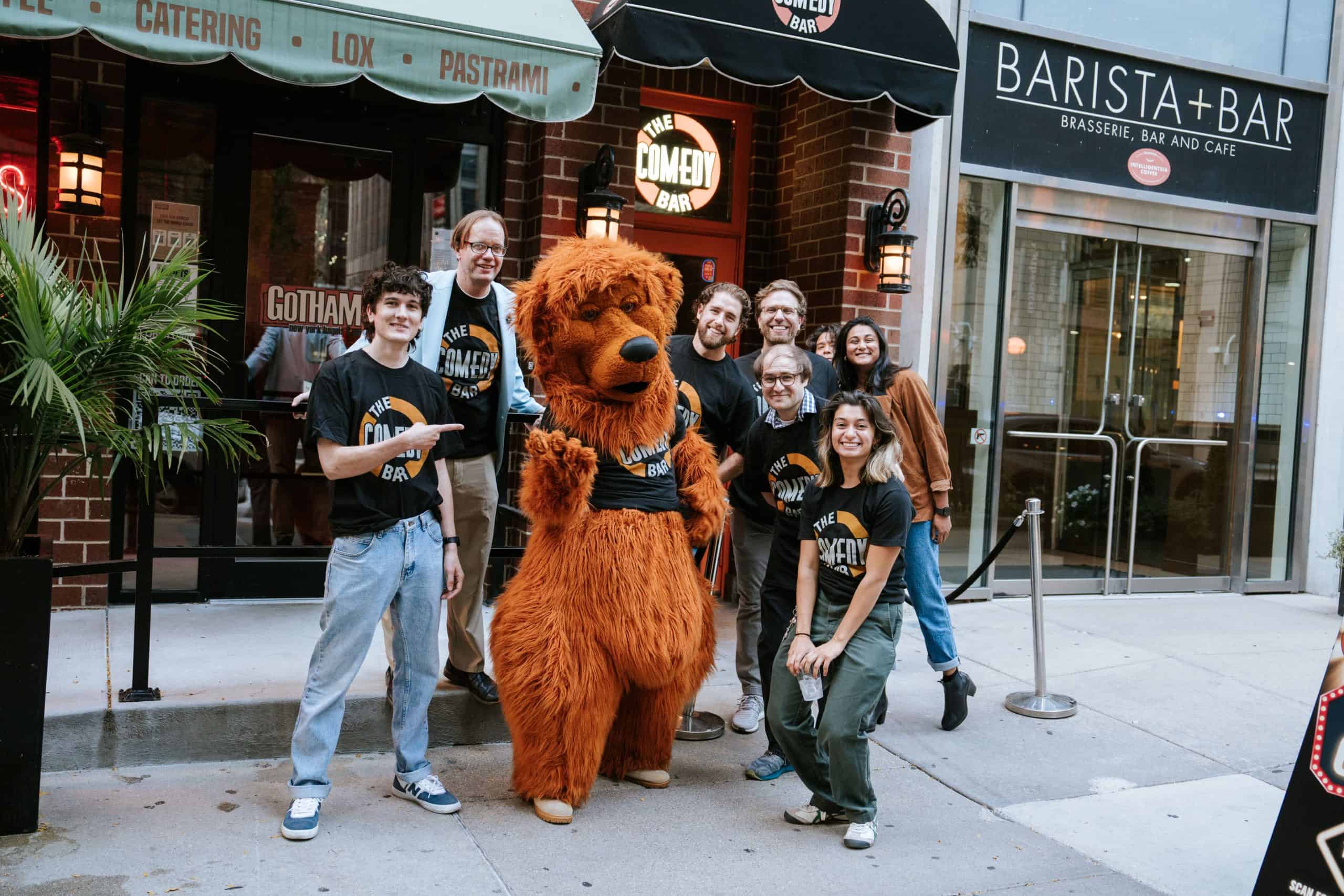 Comedy Bar Chicago team posing with bear mascot outside the venue