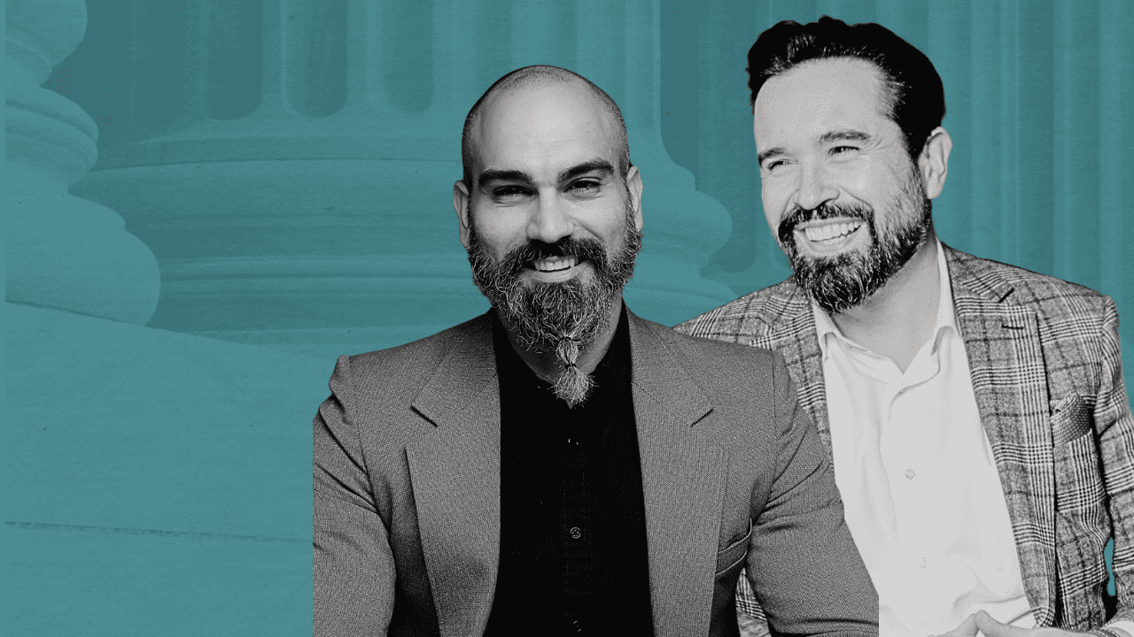 Two professional men smiling in a business setting with a teal background.
