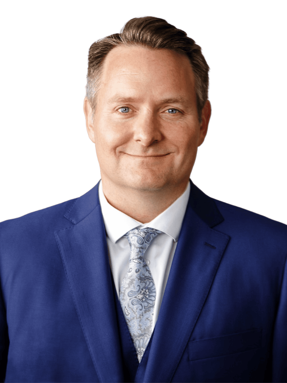 Professional man in blue suit smiling for a corporate portrait.