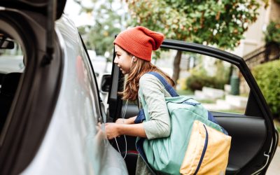 image of Teen getting into car with backpack over one shoulder