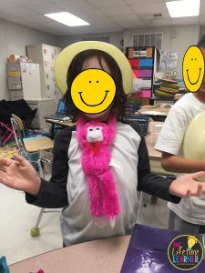 child wearing stuffed monkey