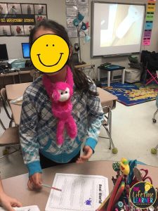 girl with stuffed monkey on neck