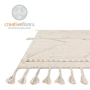 Elegant beige rug with tassels, ideal for contemporary home décor.
