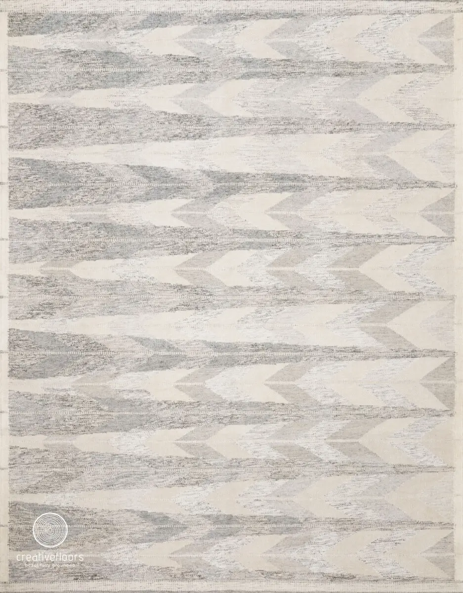Gray geometric patterned area rug with textured design for modern home decor.