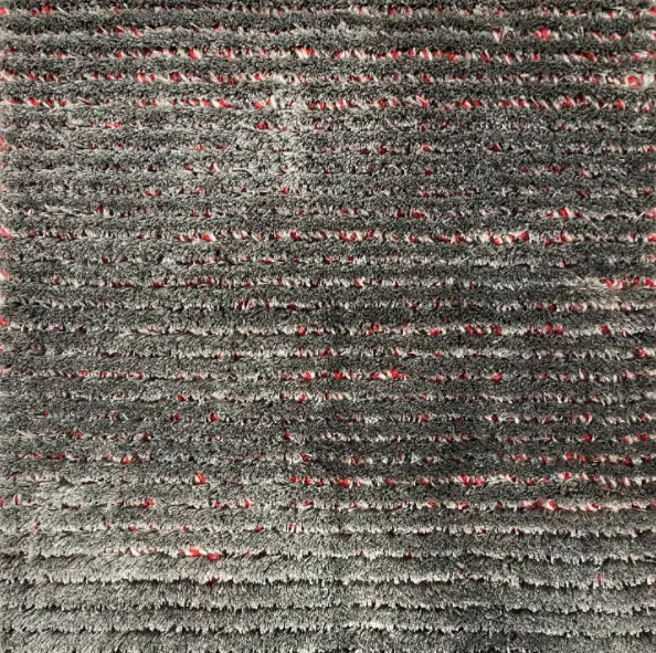High-quality textured gray carpet with red accents, perfect for residential and commercial flooring solutions.