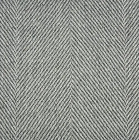 Cotton herringbone fabric in black and white for upholstery or fashion designs.