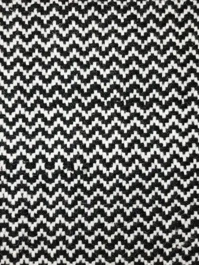 Black and white zigzag patterned carpet for modern interior flooring.
