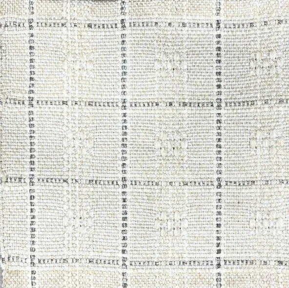 Soft white textured rug with black grid pattern, ideal for modern living spaces.
