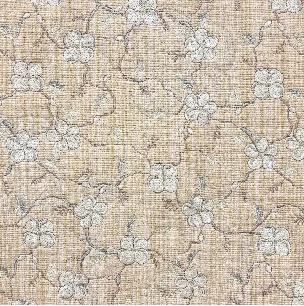 Floral patterned carpet with neutral beige tones and subtle design details.