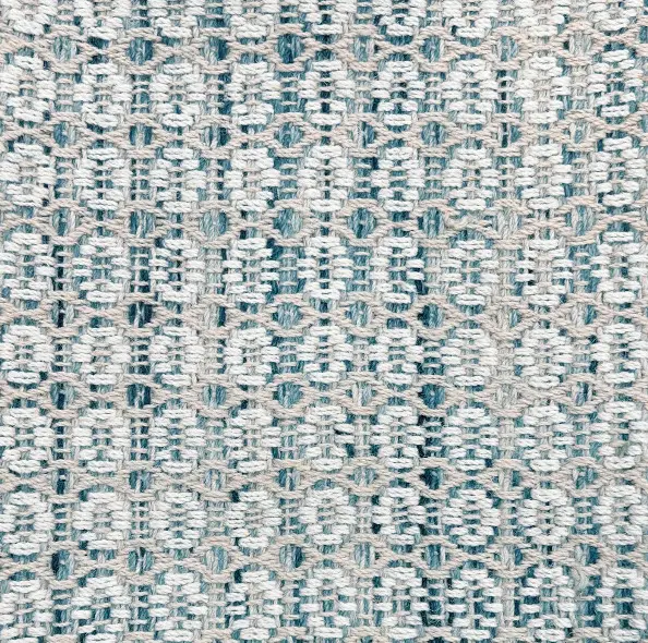 Soft woven rug with intricate pattern, ideal for modern home flooring and interior decor.