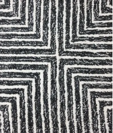 Intricate black and white geometric textured carpet for modern flooring designs.
