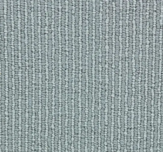 Soft gray textured carpet for residential or commercial flooring.