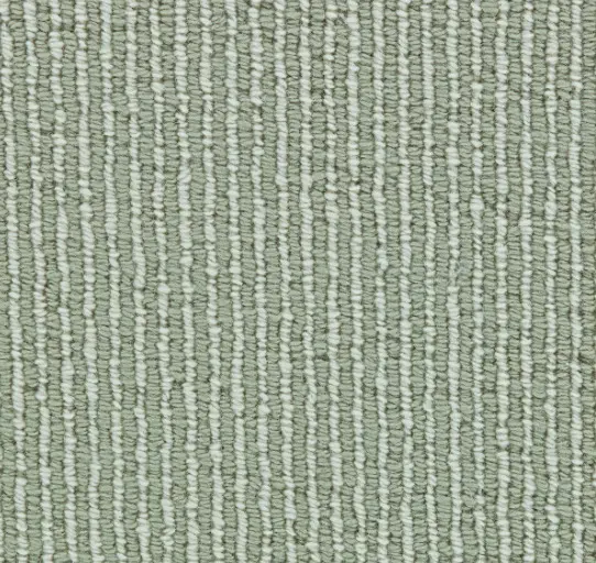 Soft green textured rug with modern design, ideal for contemporary home interiors.
