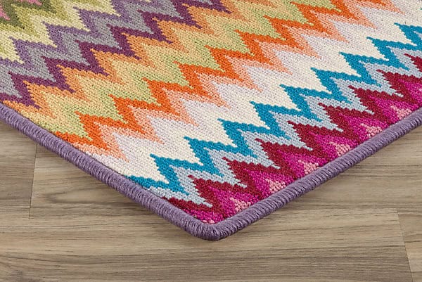 Vibrant multicolor zigzag area rug with purple border on hardwood flooring, stylish and durable for home decor.