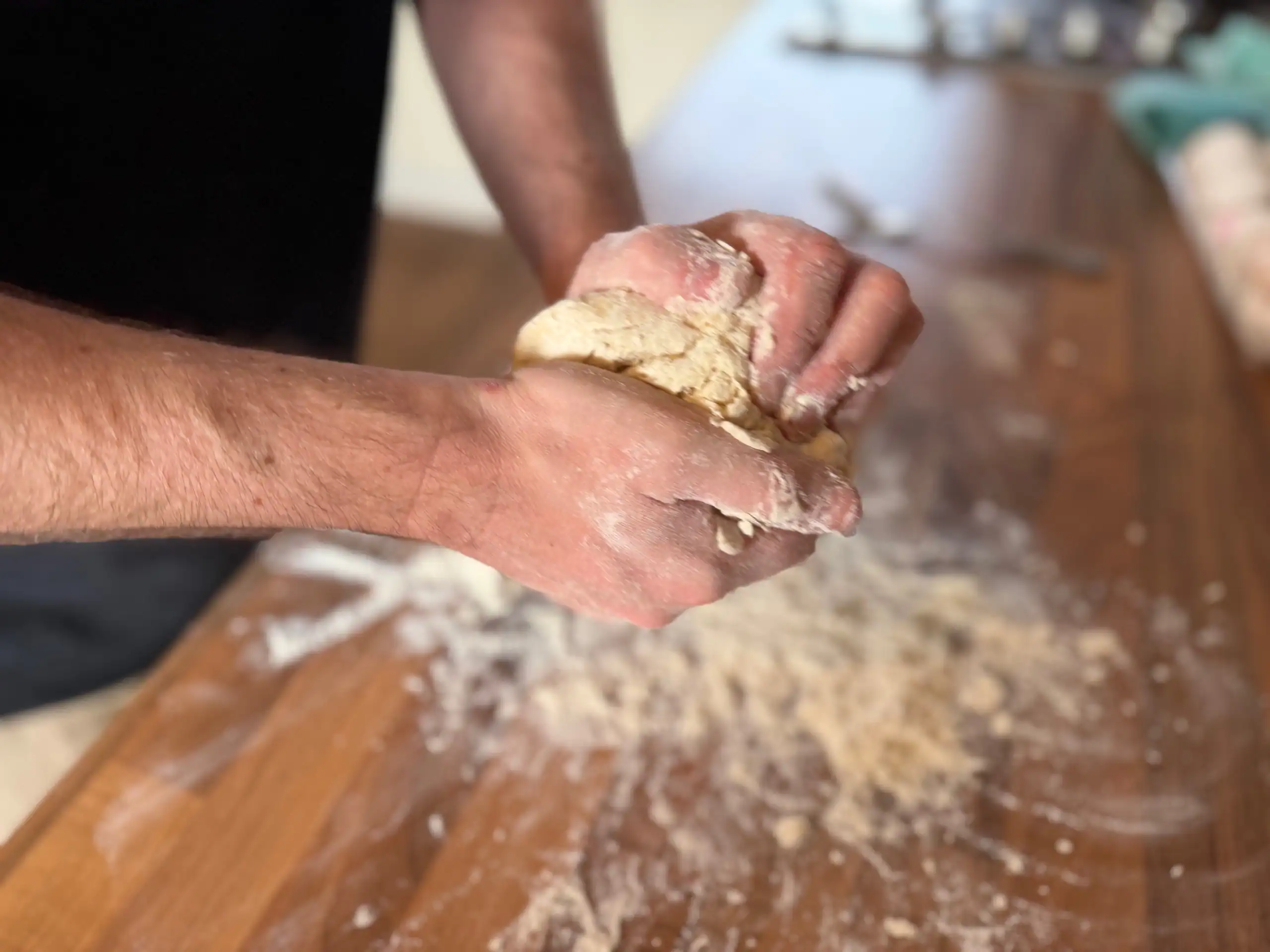 using hands to make pasta dough