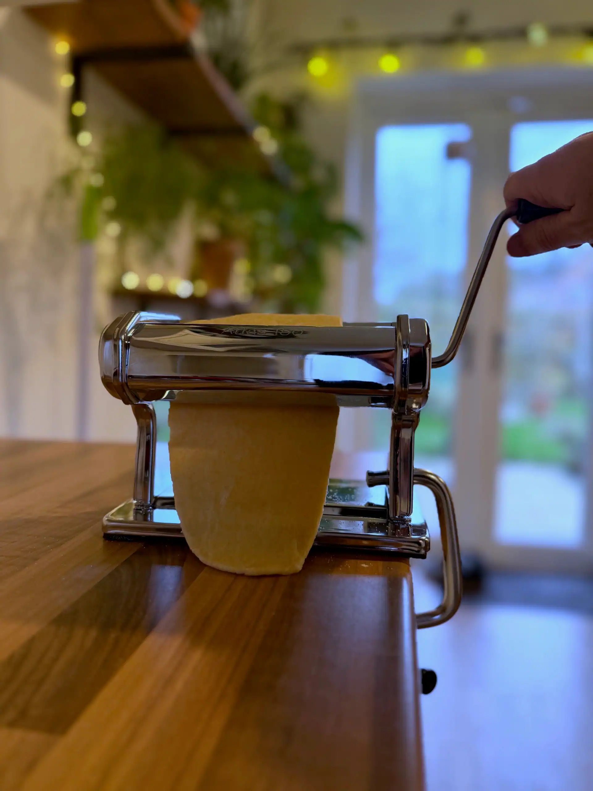 putting dough through pasta machine