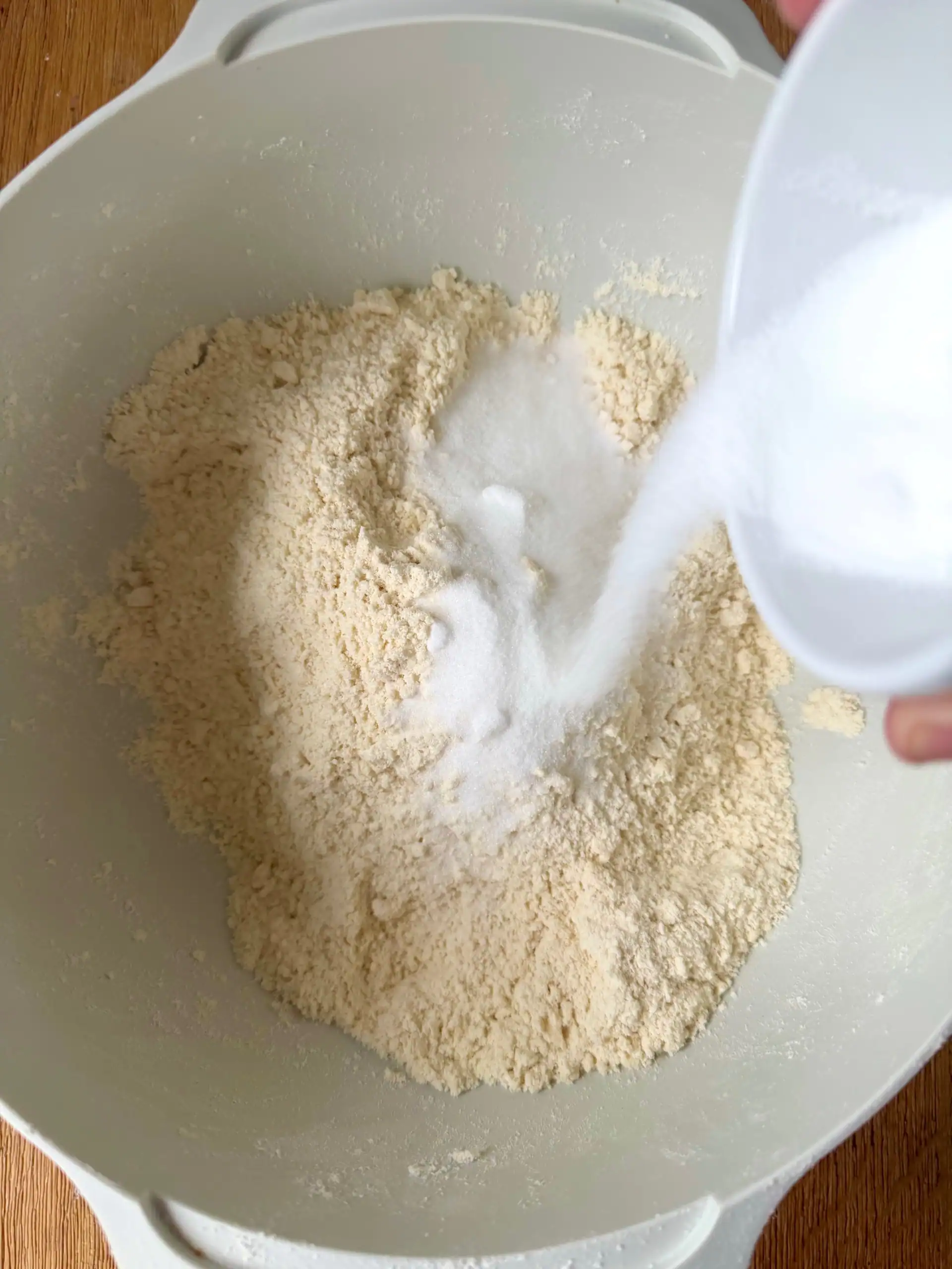 adding sugar to bowl