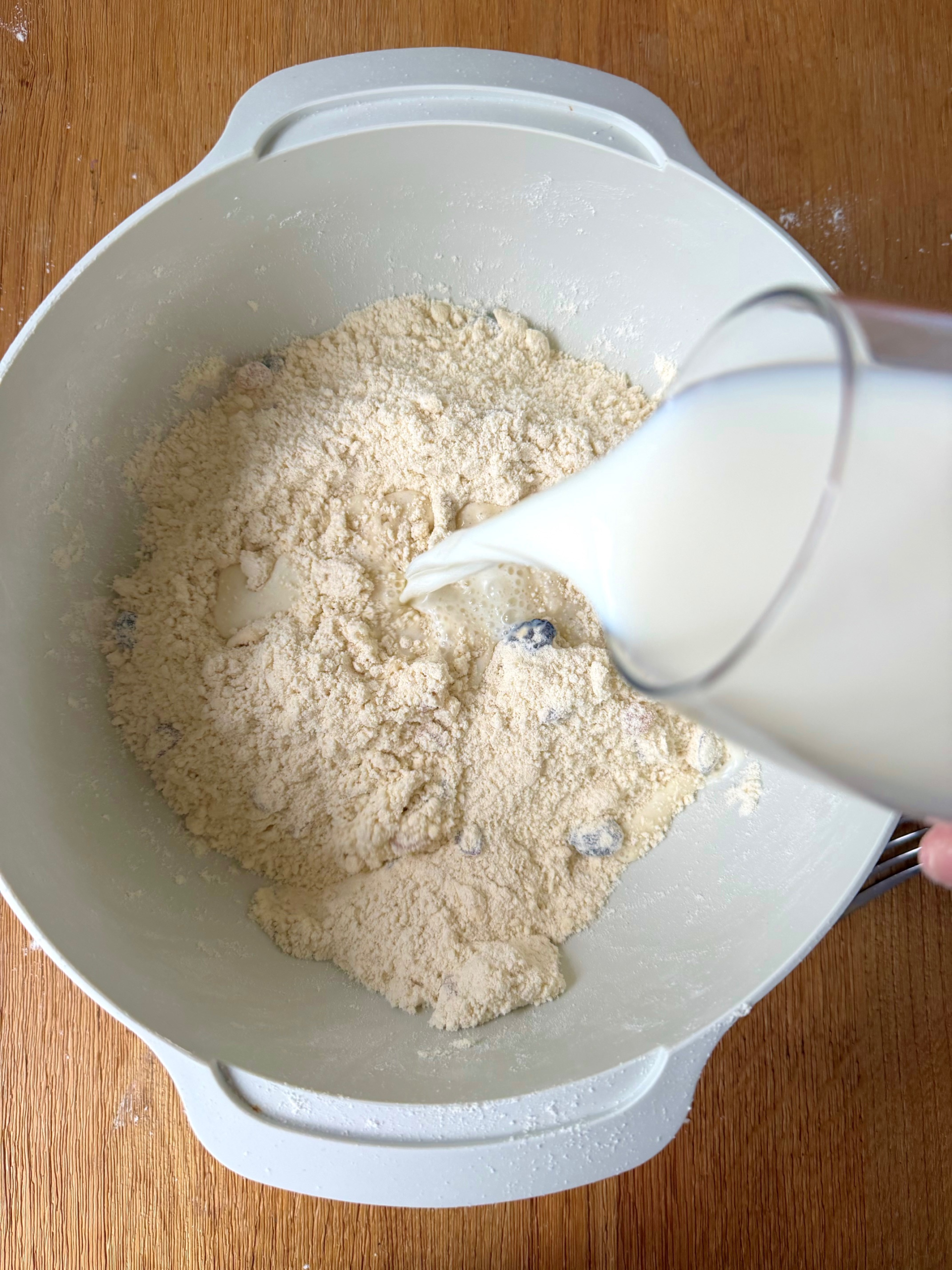 adding milk to bowl