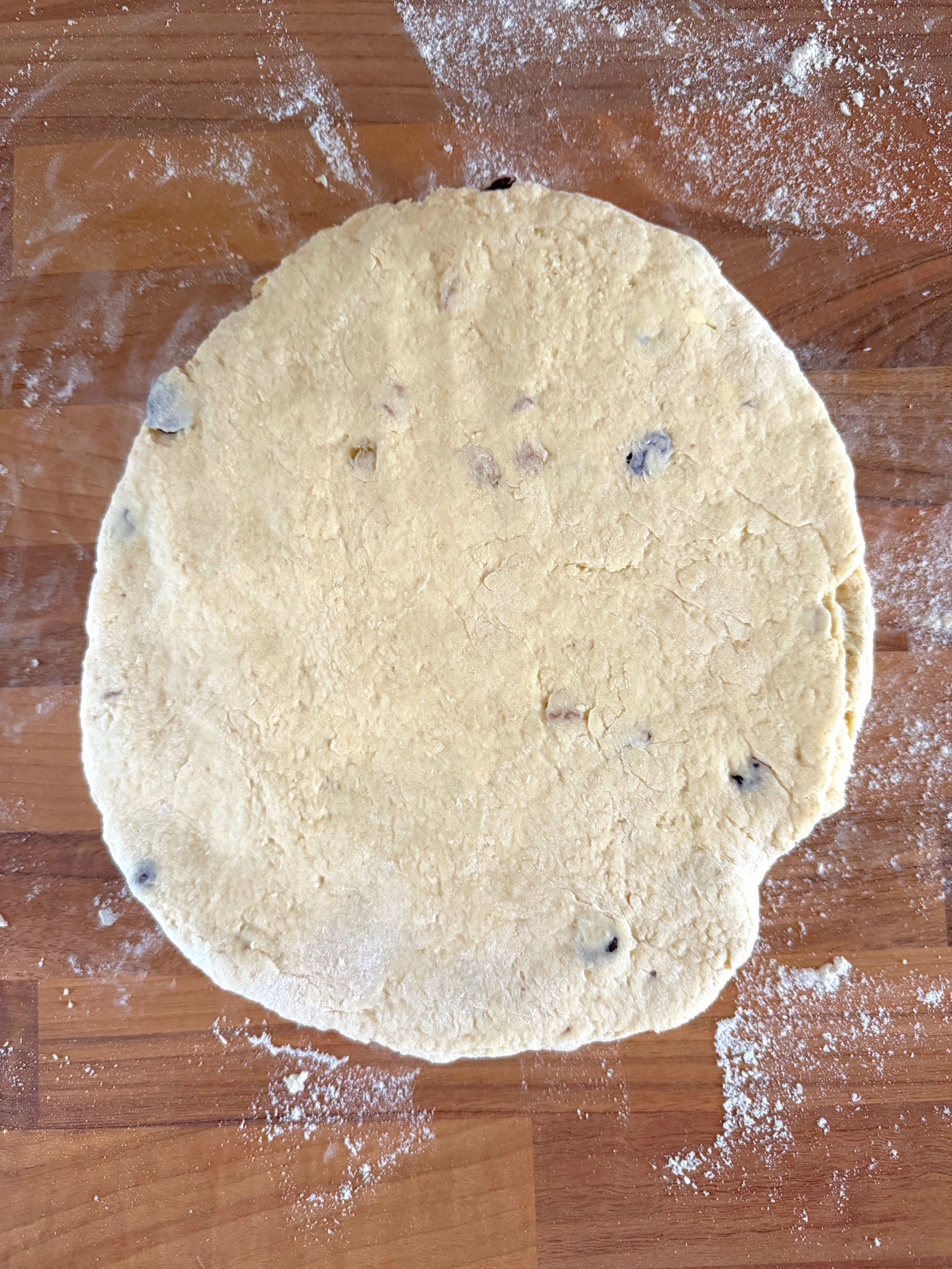 flattened dough on floured surface