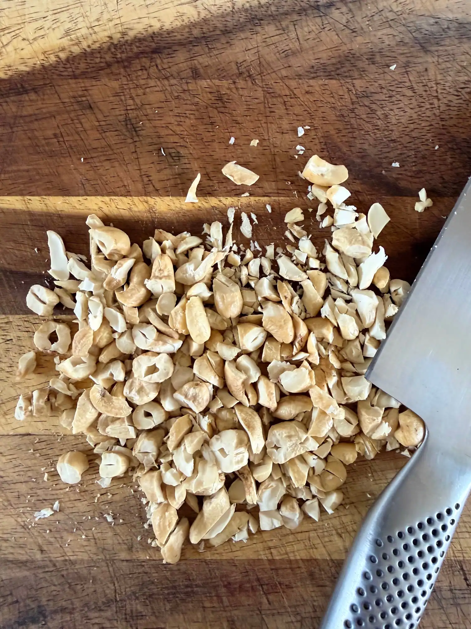 chopped cashew nits on a chopping board