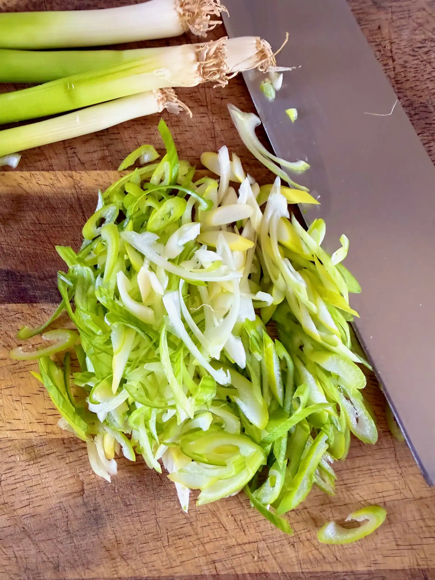 chopped spring onions on a chopping board
