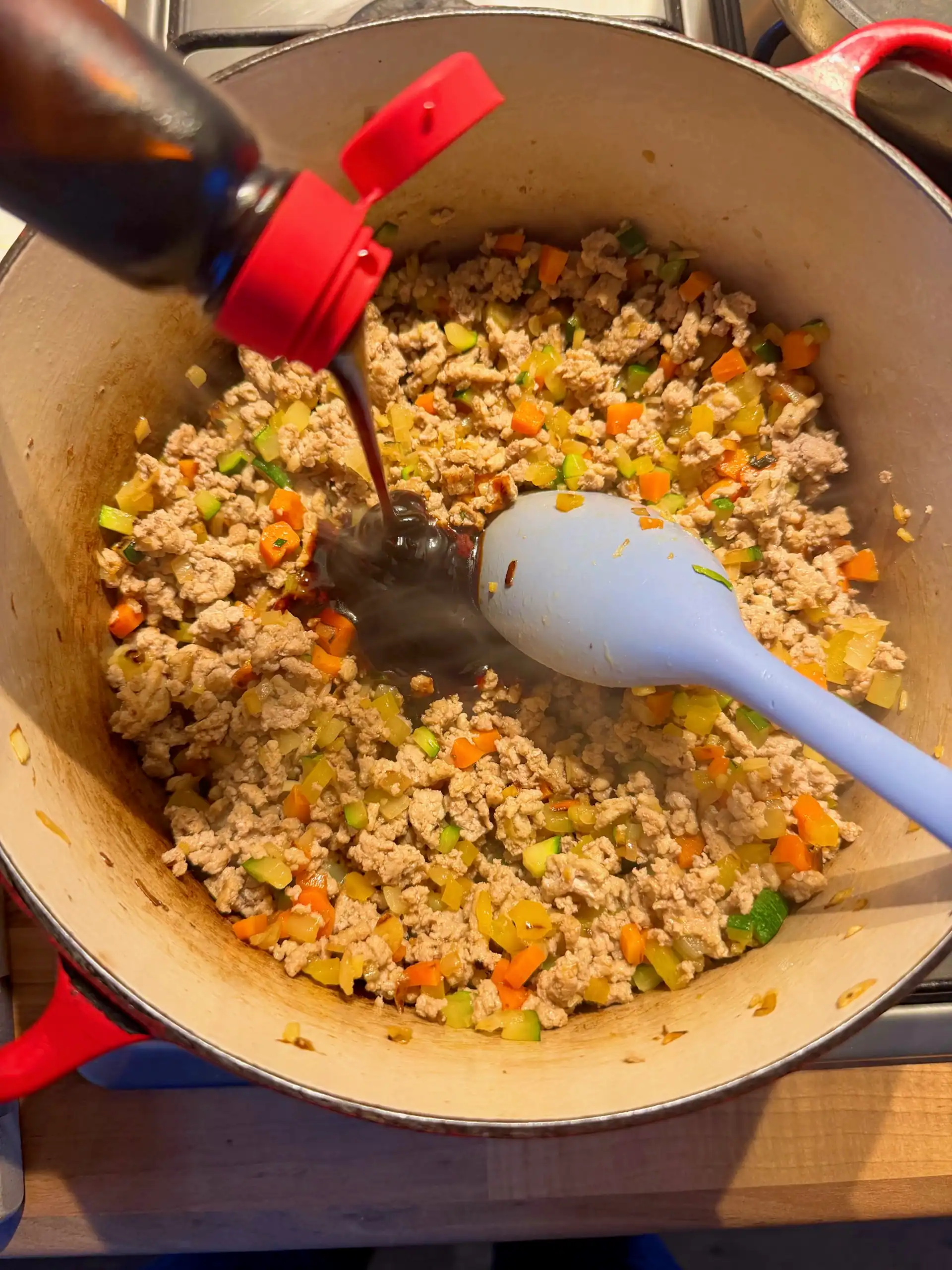 adding teriyaki sauce to turkey mix