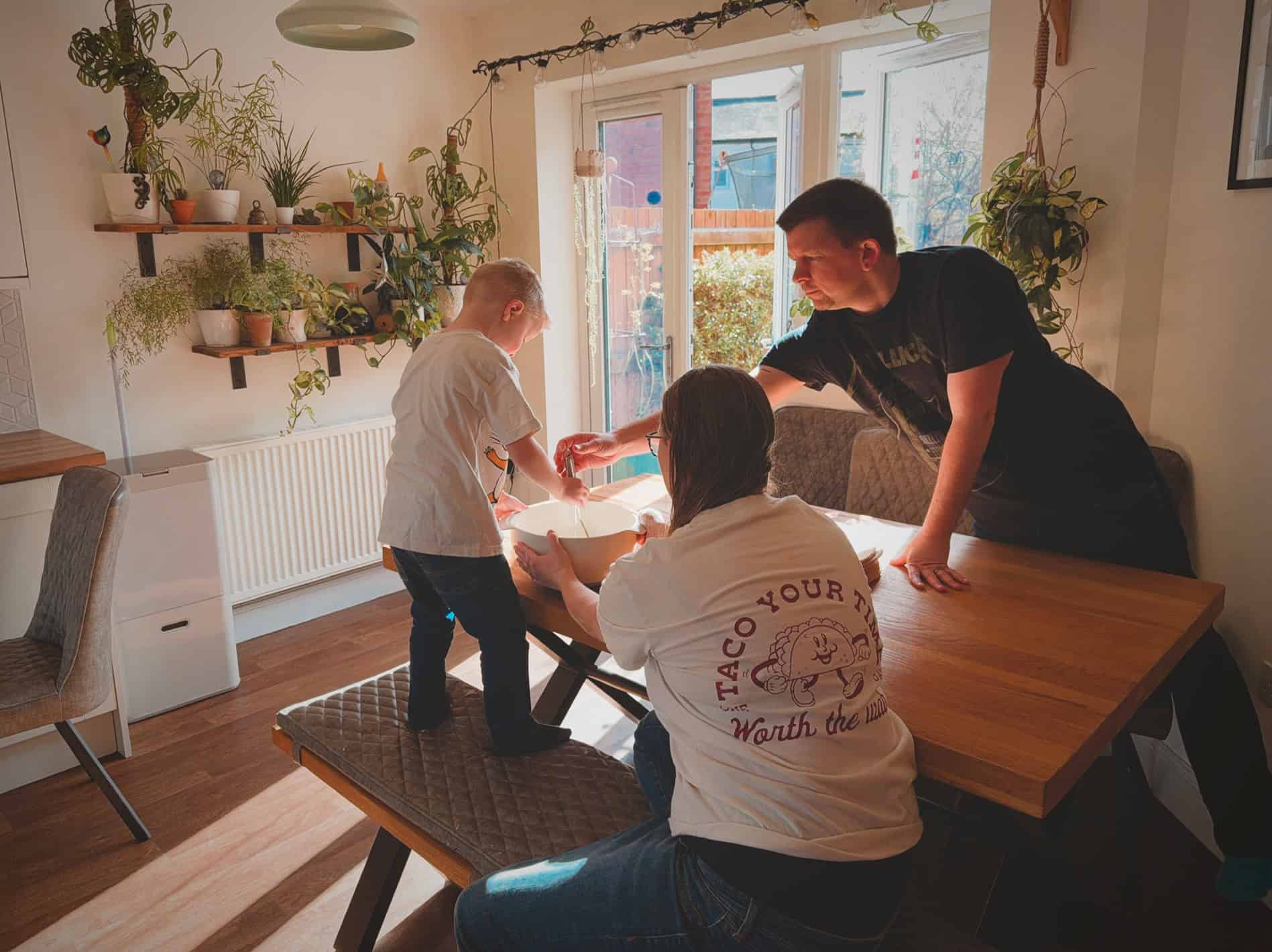 family in the kitchen sat around the dining table