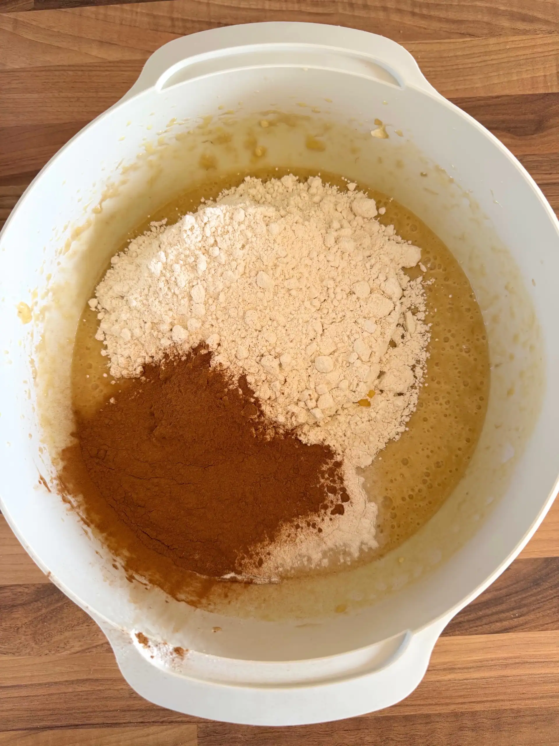 adding dry ingredients to the bowl