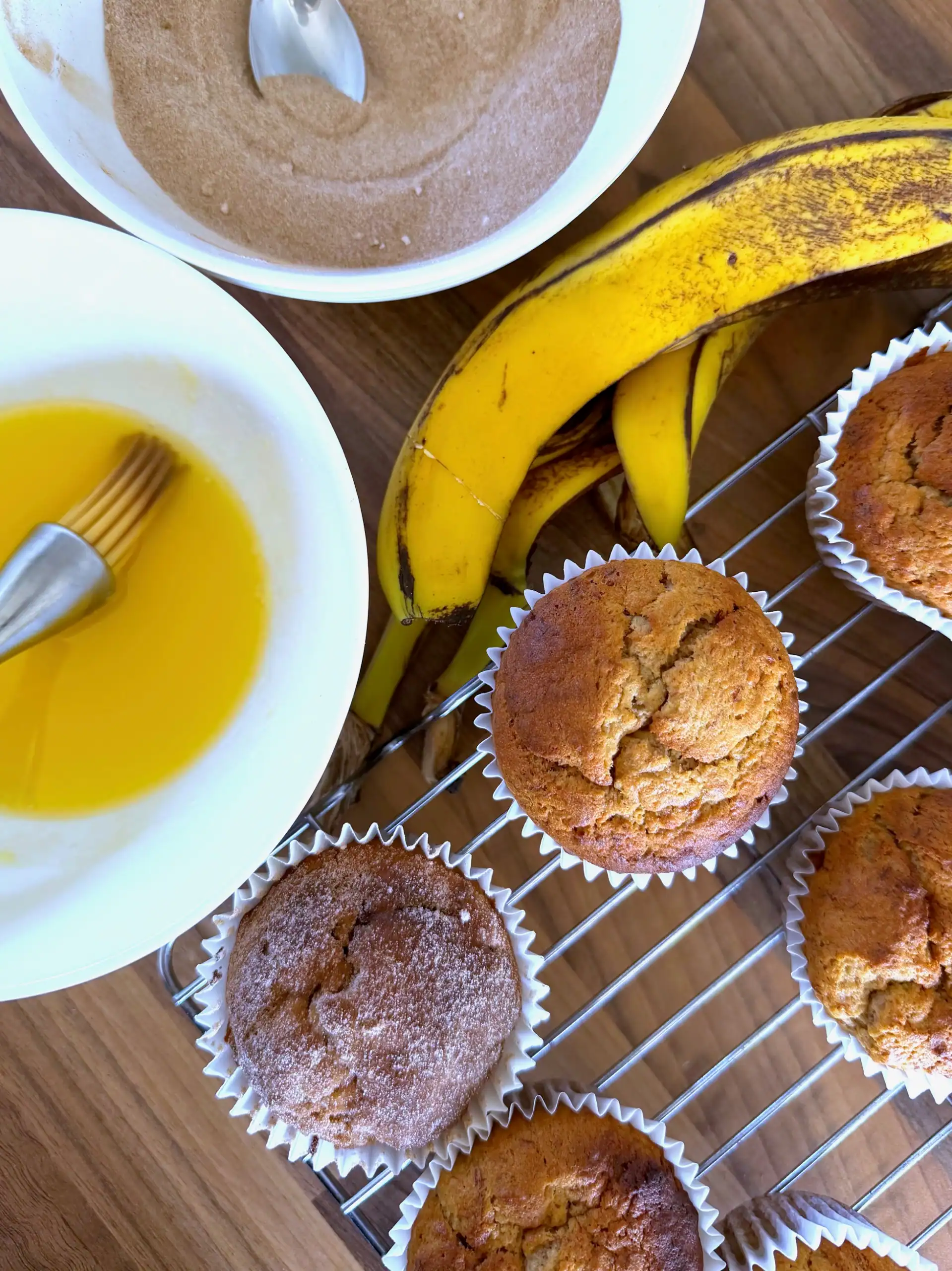 brushing muffins with butter and dipping in sugar